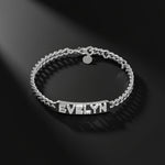 Silver bracelet with 'EVELYN' engraved on a black background
