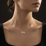 Necklace with 'Joy' pendant on a model against a black background