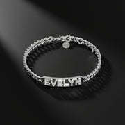Silver bracelet with 'EVELYN' engraved on a black background