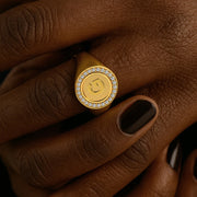 Gold ring with a face design on a hand