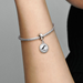 model wearing the Pandora Newfoundland Puffin Charm on a sterling silver bracelet.