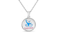 Come home year 2022 round circle pendant hung on a chain. The design on the pendant features a blue coloured whale breaching the water with the year "2022" in blue text. Below the whale reads "Come Home - Newfoundland & Labrador"
