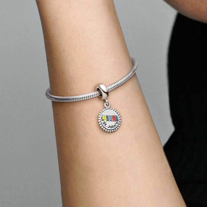 Pandora Jelly Bean Row round circle charm worn by a model with a sterling silver bracelet. The charm reads "St. John's" and features 6 coloured row houses.
